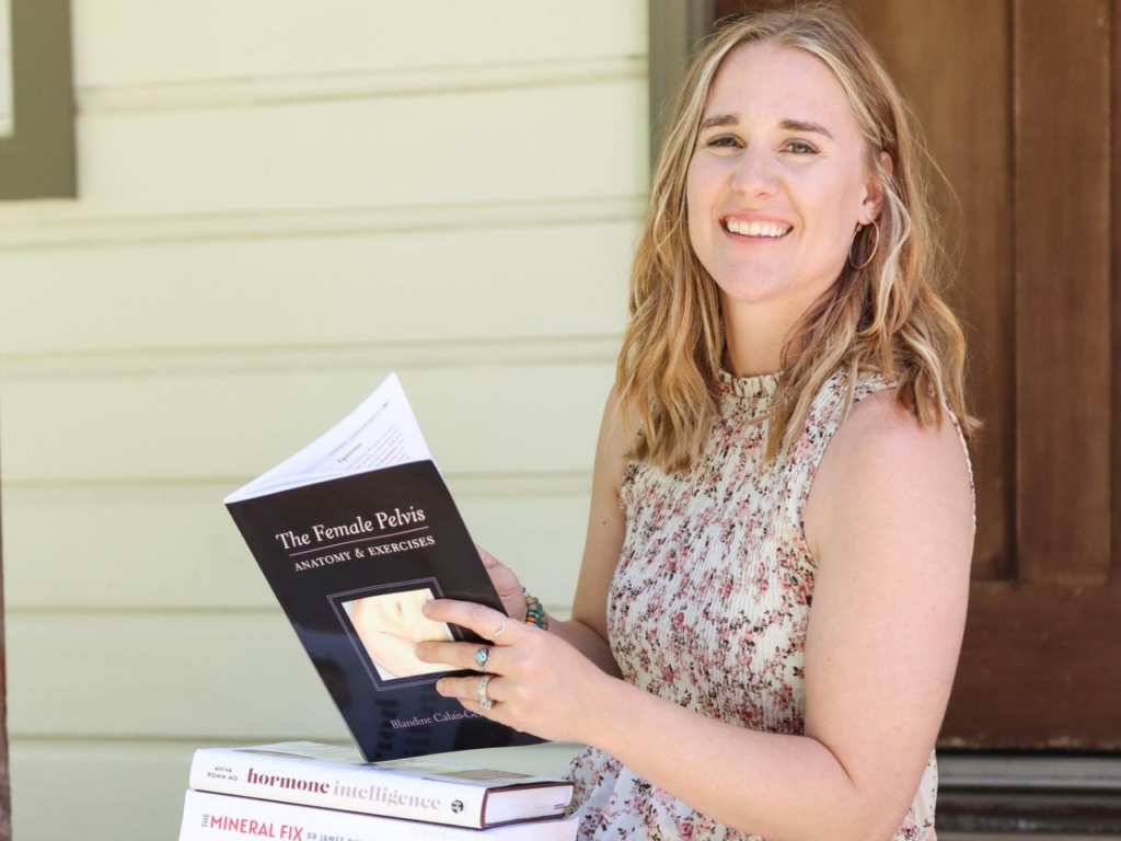 woman holding a book on women's health